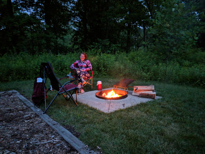 Casey sitting at the campfire